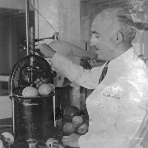 Dr A T Frascati an American scientist. Making perfume from crushed fruit. Photo shows