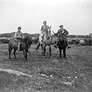 A family out, horseriding, bareback on a field. 1933
