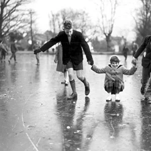 Having fun on the ice covered ponds at Chislehurst, Kent. The ice is about 12 inches