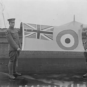 Hoisting the new Royal Air Force ensign. Members of the RAF with the Flag before