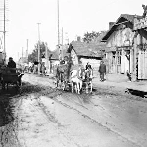 A street scene in Barowslav, showing the street six inches deep in oily liquid draining