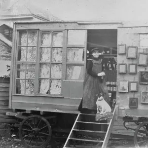 Samuel John Goviers sister, Bessie, with her dog in the doorway of Samuels photographic van, Cornwall. Early 1900s