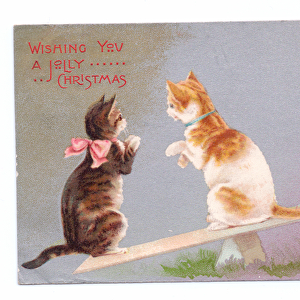 Edwardian Christmas postcard of three kittens on a see-saw, c. 1910 (colour litho)