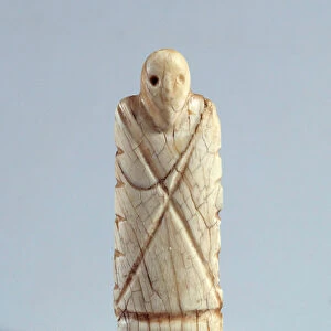 Egyptian antiquite: figurine of bearded ivory man. Period Nagada I (ca. 3800-3500)
