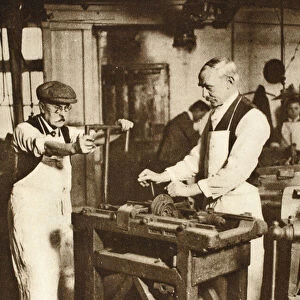 Two elderly locksmiths cutting key barrels, from Wonderful London