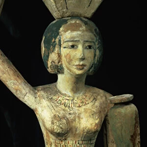 Female bearer of offerings carrying a water vase in her hand and a vessel on her head