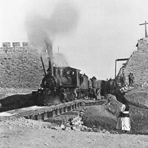 First train passing through the wall of Peking, China, c. 1900 (b / w photo)