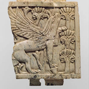 Furniture plaque carved in relief with a griffin in a floral landscape, c