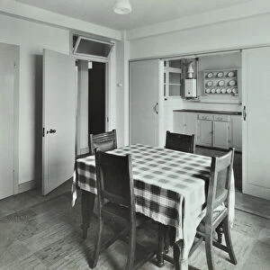 Kingsmead Estate: interior of flat, dining room and kitchen, London, 1939 (b / w photo)