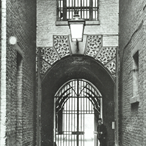 Millbank Prison: main passageway, Warden Barnard in doorway, 1885 (b / w photo)