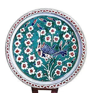 Peacock sitting on the branch of a wild rose bush (faience)