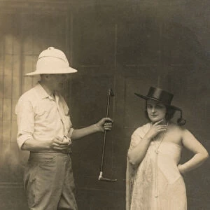 Portrait of a man dressed for riding and a woman wearing a hat and a dress (b / w photo)
