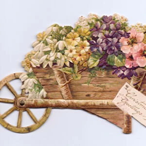 A Victorian die-cut shape Christmas card of flowers in a wheelbarrow, c