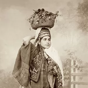 Woman with a basket of fruit on her head, c. 1867-98 (b / w photo)