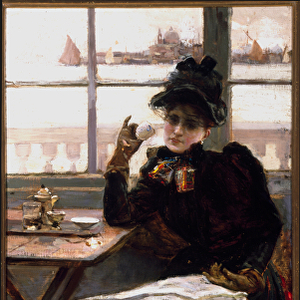 A woman in black, reading the newspaper, sipping a cup of coffee in a bistro