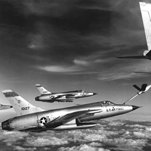 F-105 Thunderchief planes pull up to a KC-135 Stratotanker refueling aircraft, 1966