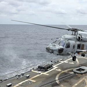An MH-60R Sea Hawk helicopter lifts off from USS Wayne E. Meyer