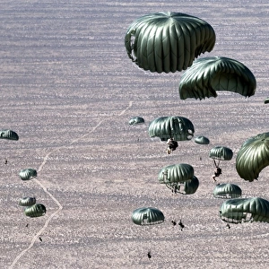Pararescuemen jump out of a C-130 Hercules