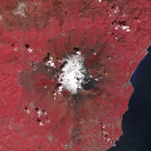 Satellite view of Mount Etna emitting plumes of volcanic gases