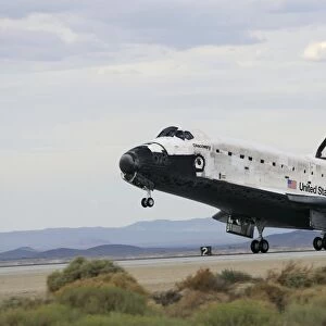 Space Shuttle Discoverys main landing gear touches down for landing