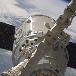 The SpaceX Dragon commercial cargo craft during grappling operations with Canadarm2