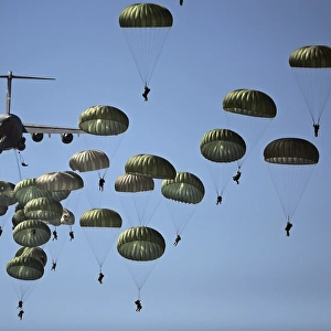 U. S. Army paratroopers jumping out of a C-17 Globemaster III aircraft
