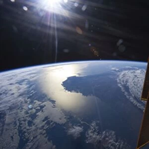 View from space of a setting Sun above part of southwestern Australia