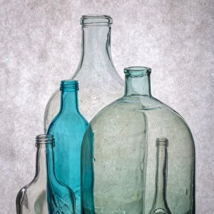Still life with different transparent glass bottles
