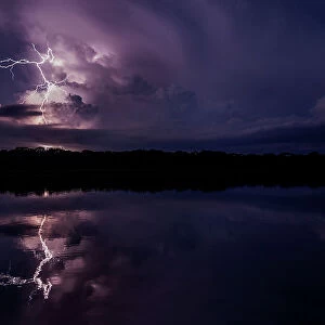 Lightning storm reflecting in river in the Amazon basin, Yasuni National Park, Orellana, Ecuador. January, 2019
