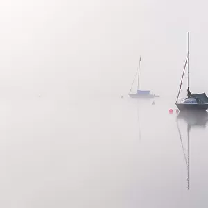 Wimbleball reservoir, mist, reflections and sailing boats, Exmoor National Park, Somerset, UK. May 2017