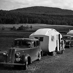 1937 Hillman 14 towing caravan. Creator: Unknown