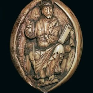 Anglo-Saxon carving of a man writing a book, 10th century