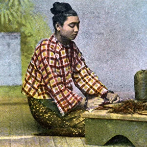 A Burmese woman making cigars, c1900s