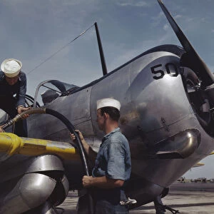 Feeding an SNC advanced training plane its essential supply of gas... Corpus Christi, Texas, 1942. Creator: Howard Hollem