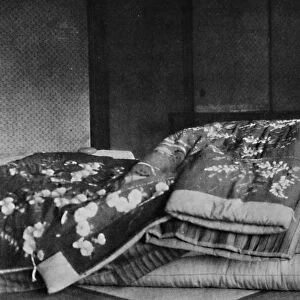 Saki, the housekeeper sleeps on a mattress with hard pillow under a quilted kimono, c1900, (1921). Artist: Julian Leonard Street