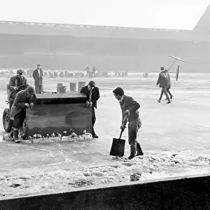 Groundsmen attempting to rid the pitch of ice at Anfield, during the bad winter of 1962/1963