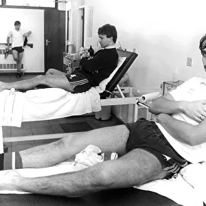 Manchester United F. C. footballers Alan Davies (front) and Bryan Robson having treatment