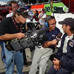 2003 Champ Car Series 25-27 July 2003 Molson Indy Vancouver Vancouver, BC. Calvin Fish of SpeedChannel interviews Darren Manning. 2003 Dan R. Boyd USA LAT Photographic