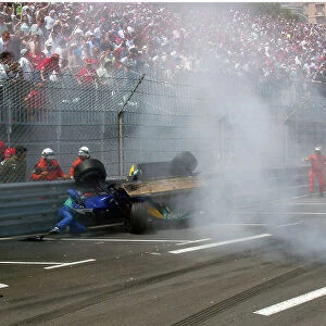 2004 Monaco Grand Prix. Monte Carlo, Monaco. 20th - 23rd May 2004. Giancarlo Fisichella climbs out from his wrecked Sauber as it lies up against the barrier. World Copyright: Adam Cooper/LAT Photographic Ref: Digital Image only