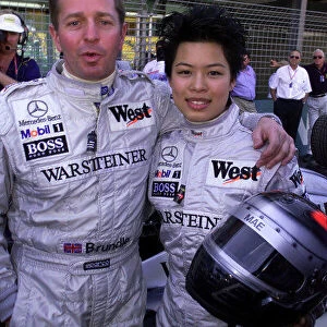 AUSTRALIAN GRAND PRIX, MELBOURNE, AUSTRALIA 7TH MARCH 1999 VANESSA MAE, FAMOUS VIOLINIST ABOUT TO HAVE A RIDE IN THE MCLAREN MERCEDES 2 SEAT F1 CAR DRIVEN BY MARTIN BRUNDLE(LEFT) PHOTO: LAWRENCE/LAT