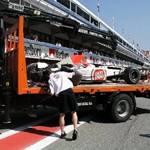 Formula One World Championship: The BAR Honda 005 Jacques Villeneuve is returned to the pits on a truck after he crashed during practice