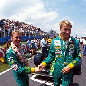 Formula One World Championship: Lotus 107 team mates Johnny Herbert and Mika Hakkinen shake hands before the start on the grid