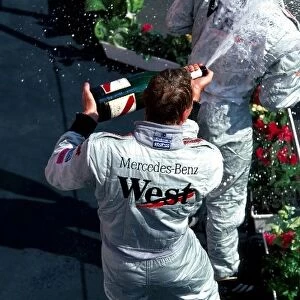 Formula One World Championship: The podium: race winner Mika Hakkinen McLaren, with second placed team mate David Coulthard McLaren