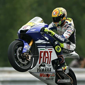 Valentino Rossi Fiat Yamaha Team celebrates topping the opening Free Practice session with a wheelie