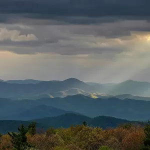 Mount Pisgah and Cold Mountain dominate the Blue Ridge Mountains as afternoon sunlight streams through storm clouds