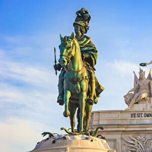 Statue of King Jose I in Commerce Square (Praca do Comercio) with Arco da Rua Augusta in the background against a blue sky in Lisbon, Portugal