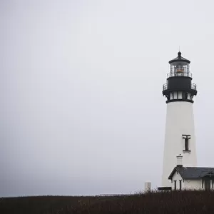 Yaquina Head Lighthouse Is Surrounded By Fog; Newport, Oregon, United States Of America