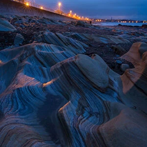Light falling on the rocks on Berwick beach, Northumberland, England
