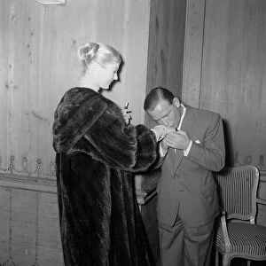 Actor and comedian Norman Wisdom kisses the hand of actress Anita Ekberg at the savoy