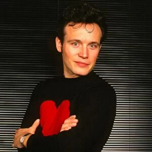 Adam Ant pop singer January 1990 Arms folded black jumper red heart - Stuart